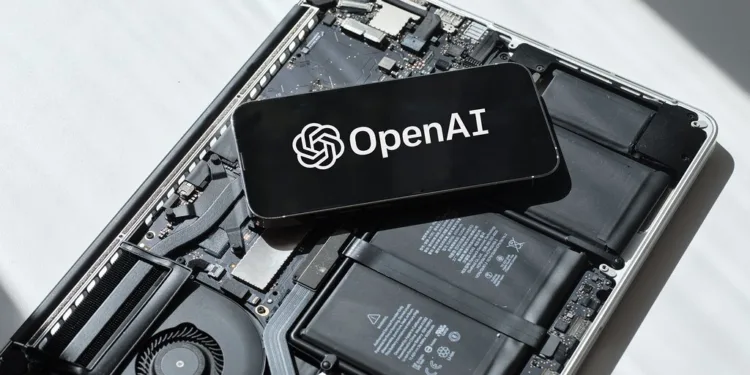 Smartphone displaying OpenAI logo placed on an open laptop motherboard representing GPT-4o update rollback and AI technology.