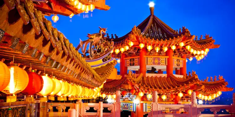 Traditional Chinese temple illuminated at night in Malaysia, representing the site of the first AI version of Mazu