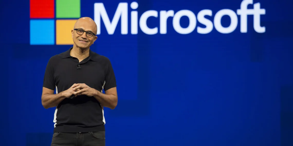 Satya Nadella speaking on stage at a Microsoft event, highlighting the role of computational thinking in software development.