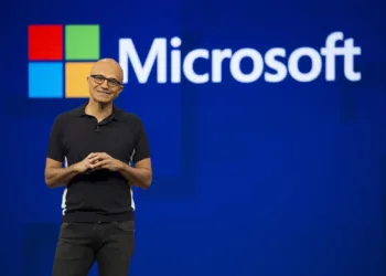 Satya Nadella speaking on stage at a Microsoft event, highlighting the role of computational thinking in software development.