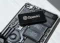 Smartphone displaying OpenAI logo placed on an open laptop motherboard representing GPT-4o update rollback and AI technology.