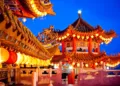 Traditional Chinese temple illuminated at night in Malaysia, representing the site of the first AI version of Mazu