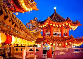 Traditional Chinese temple illuminated at night in Malaysia, representing the site of the first AI version of Mazu