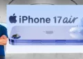 iPhone 17 Air teaser image showcasing ultra-slim design with Apple executive standing beside promotional banner